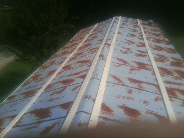 Rusted metal roof panels with new wood purlins before replacement — Storm Damage Roof Repair in Gautier by Roofing Brothers